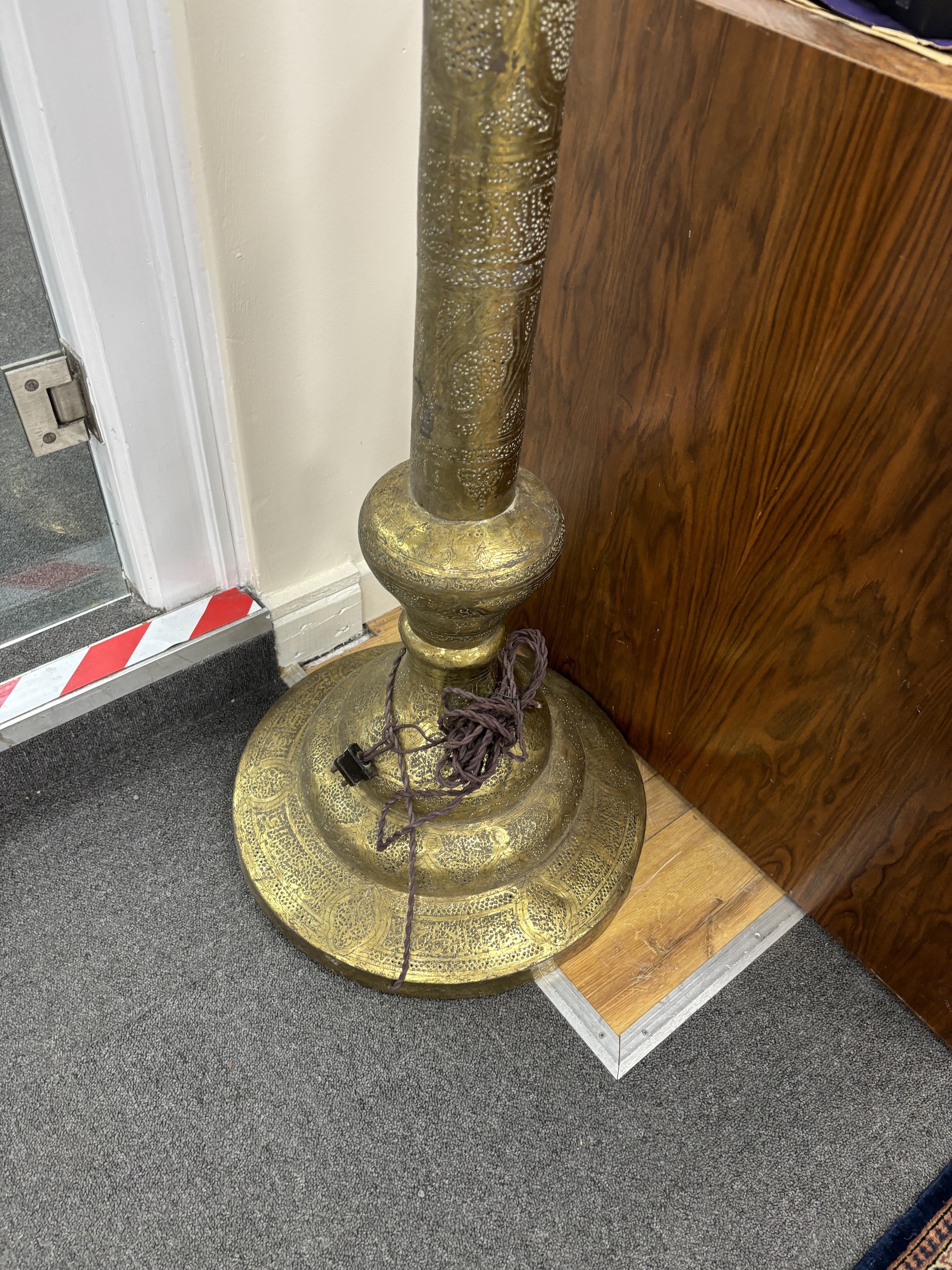 An early 20th century Indian brass floor lamp with associated opaque glass flambé shade, height 184cm